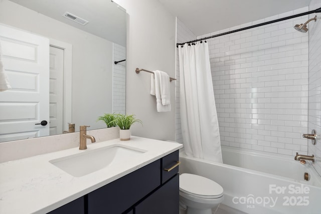 full bathroom featuring toilet, shower / tub combo with curtain, and vanity