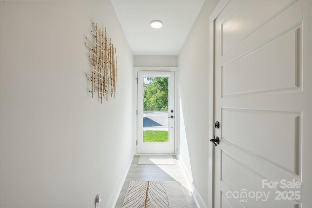 entryway featuring wood finished floors and baseboards