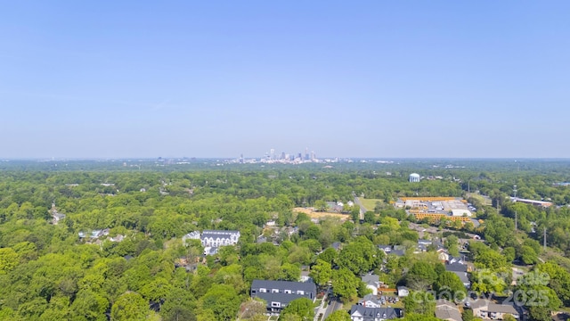 aerial view of property's location featuring a forest
