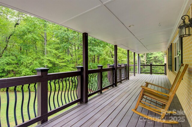 wooden deck with a view of trees