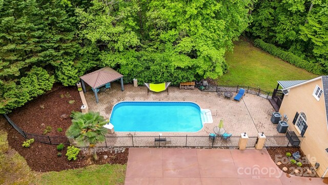 view of swimming pool with fence, a fenced in pool, and a patio