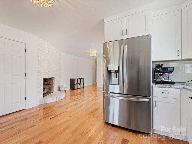 kitchen featuring white cabinetry, light wood-style floors, and stainless steel fridge with ice dispenser