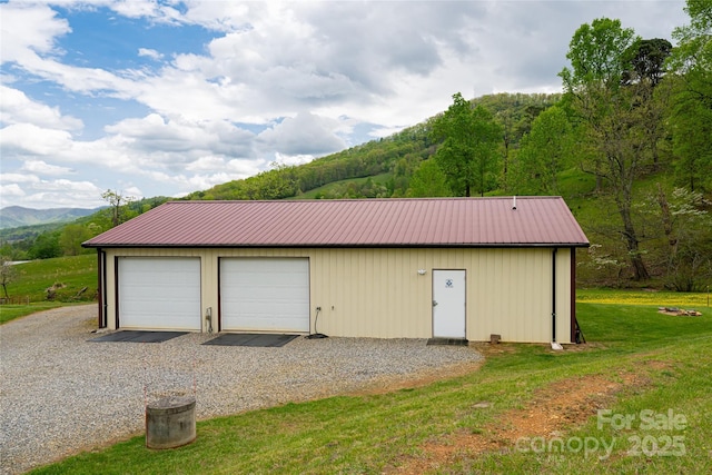 detached garage featuring a mountain view