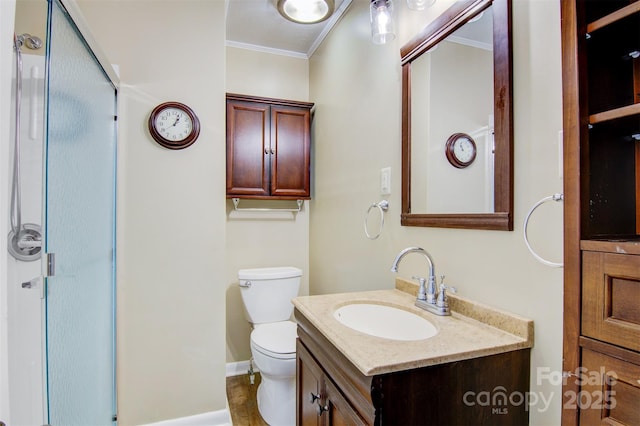 full bathroom with crown molding, vanity, toilet, baseboards, and a stall shower