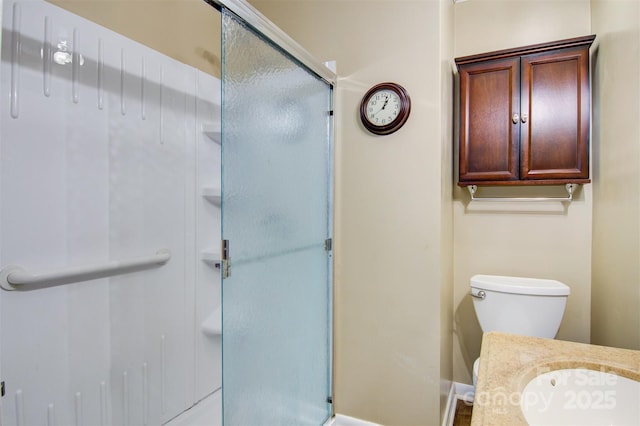 bathroom featuring baseboards, a shower stall, and toilet