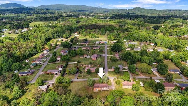 aerial view with a view of trees and a mountain view
