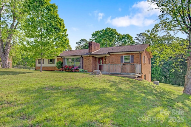 ranch-style home featuring brick siding, a chimney, and a front lawn