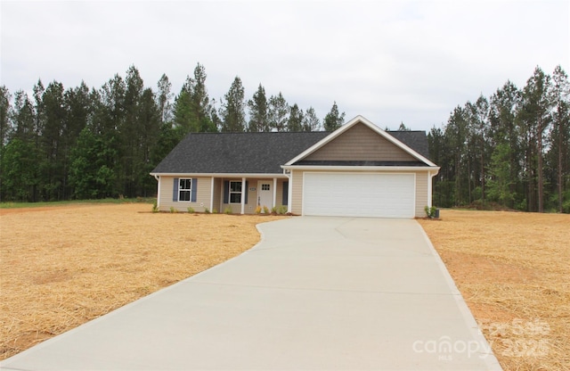 view of front of home with an attached garage, driveway, and a front yard