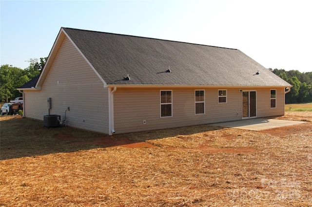 back of property with central air condition unit and a patio area