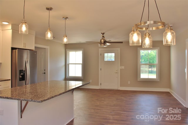 kitchen with stainless steel fridge with ice dispenser, dark wood-style flooring, white cabinetry, and open floor plan