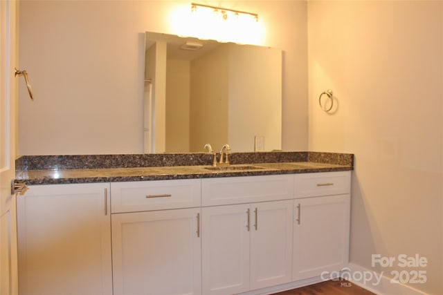 bathroom featuring baseboards and vanity