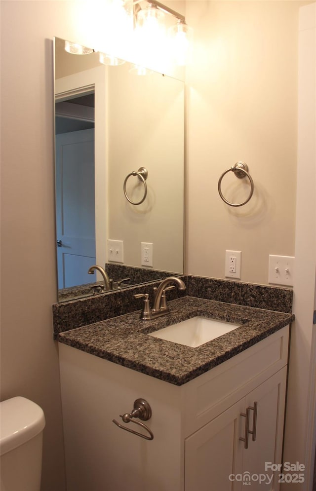 bathroom with toilet and vanity