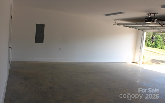 garage featuring baseboards, a garage door opener, and electric panel