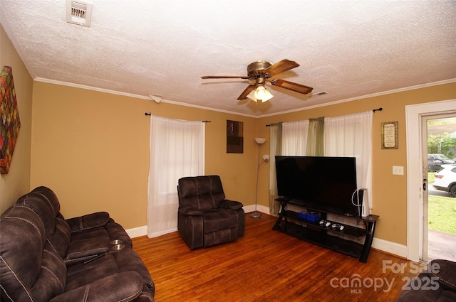 615 Mauney Ave, Kings Mountain, NC 28086 - living room featuring visible vents, wood finished floors, a ceiling fan, and a textured ceiling