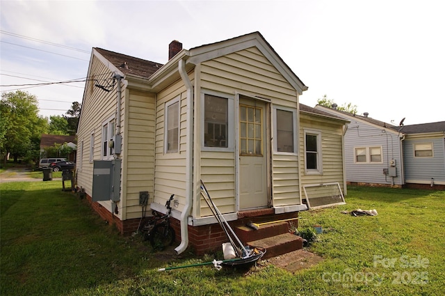 615 Mauney Ave, Kings Mountain, NC 28086 - back of house with a yard, entry steps, and a chimney