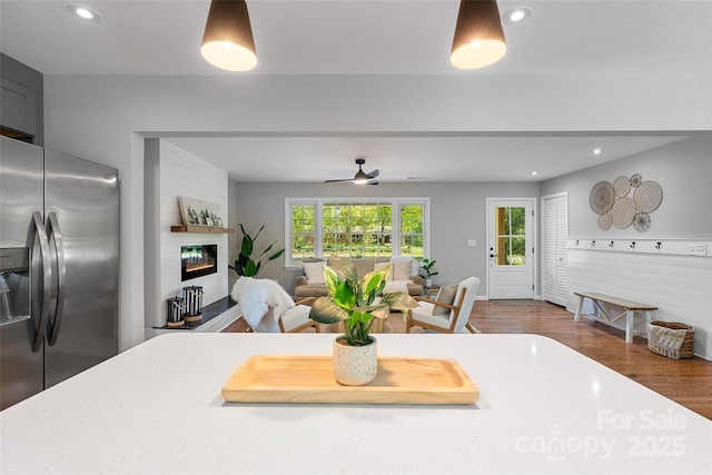 75 White Pine Dr, Fletcher, NC 28732 - kitchen with a glass covered fireplace, wood finished floors, stainless steel fridge, light countertops, and recessed lighting