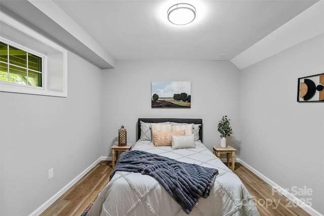 75 White Pine Dr, Fletcher, NC 28732 - bedroom with baseboards, vaulted ceiling, and wood finished floors