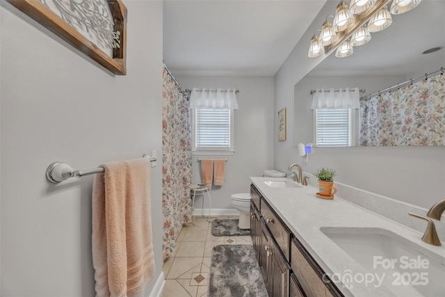 5507 Land Harbour Dr, Granite Falls, NC 28630 - full bath with tile patterned floors, toilet, double vanity, a shower with shower curtain, and baseboards