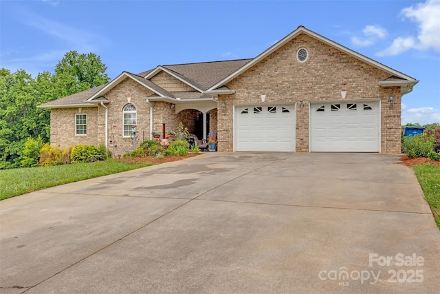 5507 Land Harbour Dr, Granite Falls, NC 28630 - view of front of home with concrete driveway, a garage, brick siding, and a shingled roof