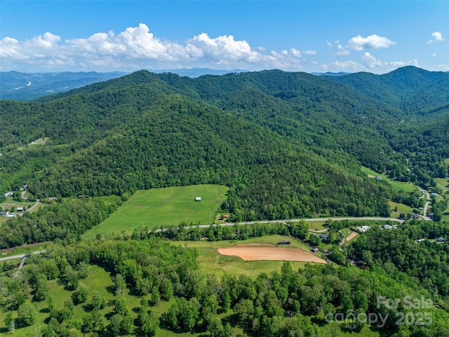aerial view with a wooded view and a mountain view