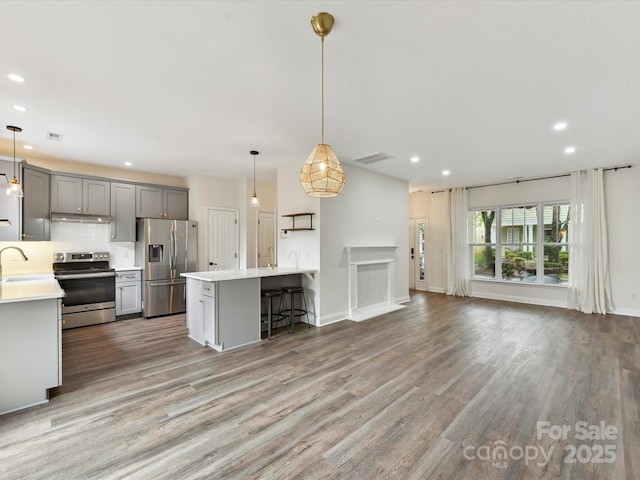 240 Faust Rd, Davidson, NC 28036 - kitchen featuring appliances with stainless steel finishes, light countertops, gray cabinets, recessed lighting, and backsplash