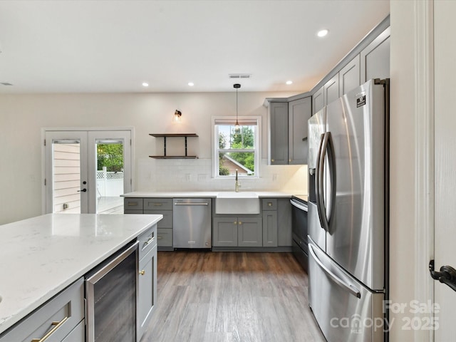 240 Faust Rd, Davidson, NC 28036 - kitchen featuring stainless steel appliances, gray cabinetry, a sink, wine cooler, and backsplash