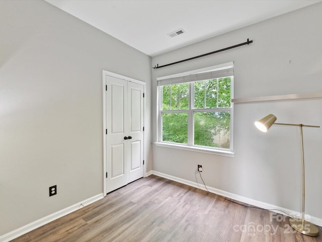 240 Faust Rd, Davidson, NC 28036 - unfurnished bedroom with wood finished floors, baseboards, and a closet