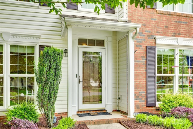 property entrance with brick siding