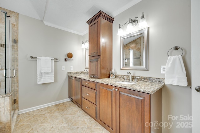 bathroom featuring double vanity, a shower stall, ornamental molding, and a sink