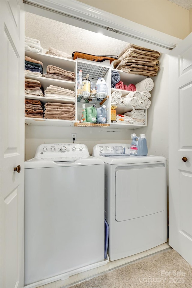 laundry area featuring tile patterned flooring, independent washer and dryer, and laundry area
