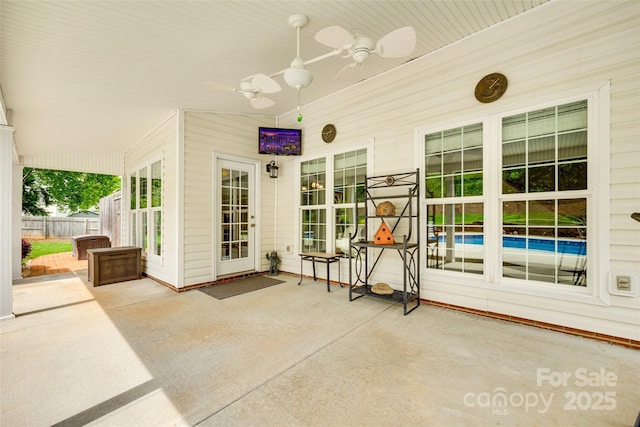 view of patio with fence and a ceiling fan