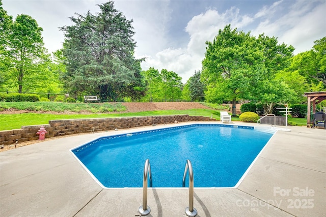 outdoor pool featuring fence and a patio area
