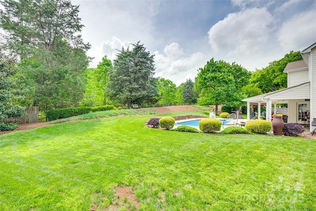 view of yard with a patio, an outdoor pool, and fence