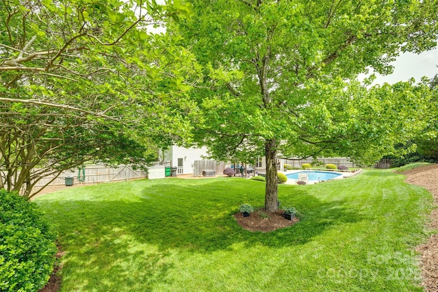 view of yard featuring a fenced in pool and a fenced backyard