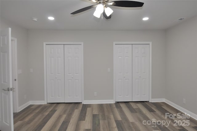 602 Still St Unit 1Blk C, Chester, SC 29706 - unfurnished bedroom featuring visible vents, multiple closets, dark wood finished floors, and baseboards