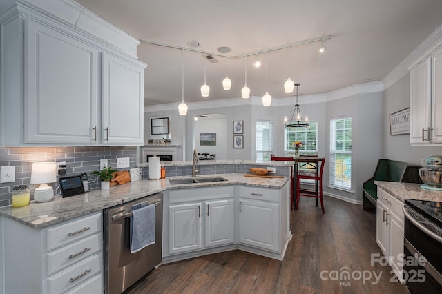 7905 Sedgebrook Dr E, Stanley, NC 28164 - kitchen featuring appliances with stainless steel finishes, a sink, a peninsula, dark wood-style floors, and white cabinets