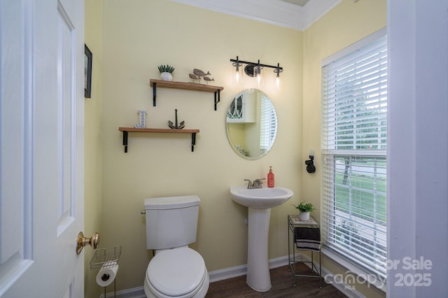 7905 Sedgebrook Dr E, Stanley, NC 28164 - half bathroom featuring toilet, baseboards, wood finished floors, ornamental molding, and a sink