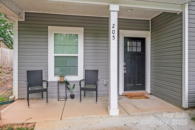 view of exterior entry featuring a porch