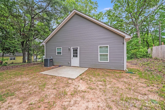 back of property with central AC unit, a patio area, and fence