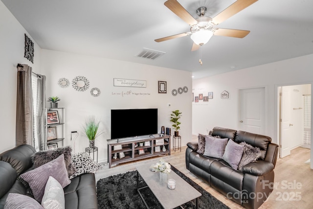 living room with ceiling fan, light wood-style flooring, and visible vents
