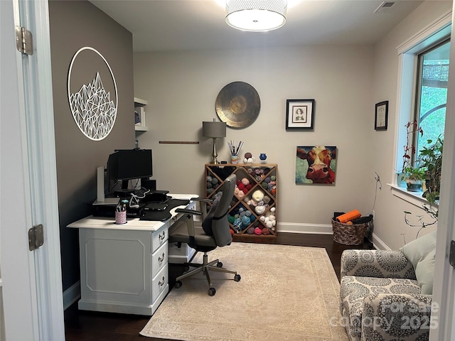 office space with dark wood-style flooring and baseboards