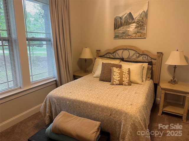 carpeted bedroom featuring baseboards