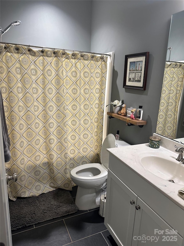 bathroom with tile patterned floors, toilet, and vanity