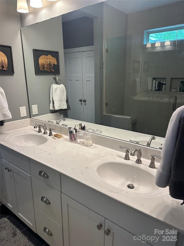 bathroom featuring double vanity, a sink, and a shower stall