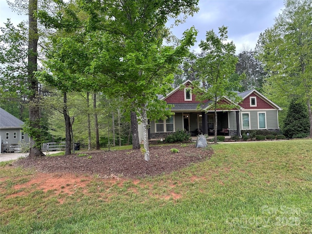 craftsman inspired home featuring a front lawn and covered porch