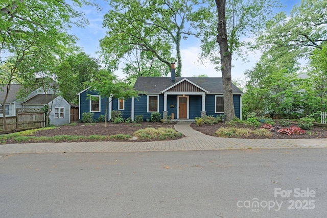 view of front of house with fence and a chimney