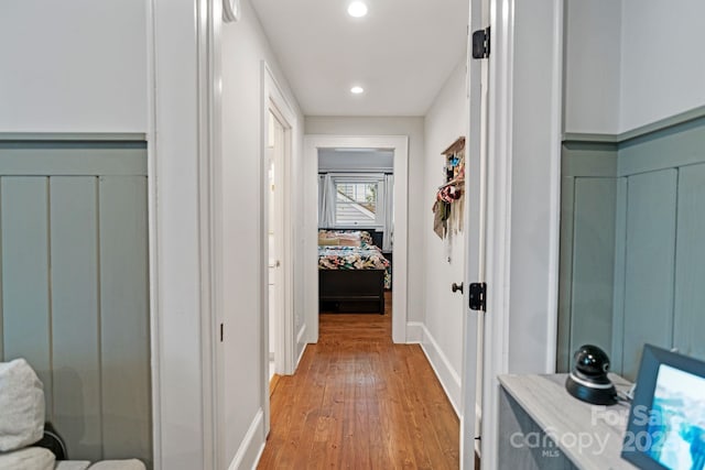 corridor featuring light wood-style floors, recessed lighting, and baseboards