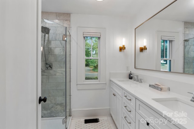bathroom with a stall shower and a sink