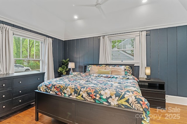 bedroom featuring wood finished floors, recessed lighting, and multiple windows