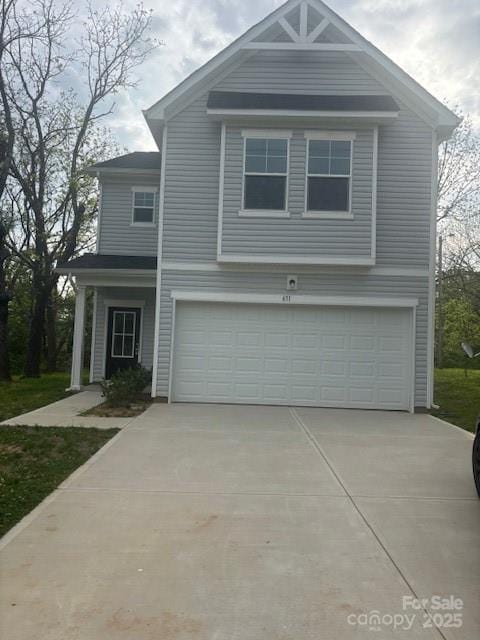 traditional home featuring a garage and driveway